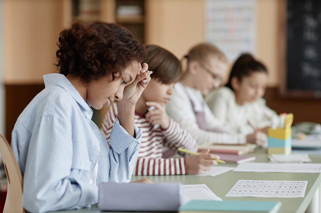 A Group of Kids Sitting at a Desk in a Classroom Free Stock Photo by Everypixel