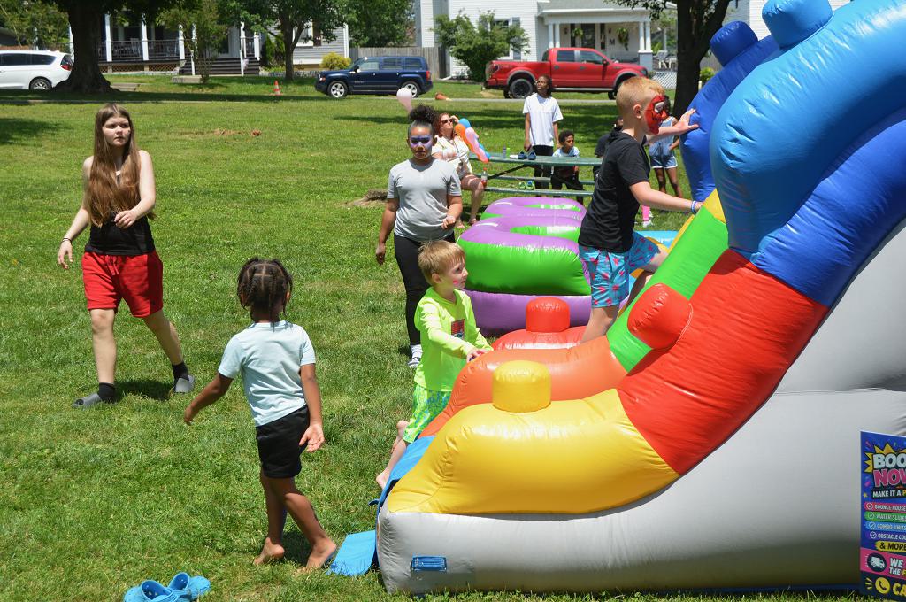 Children play on an inflatable slide at the domestic violence awareness event.