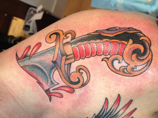 Tattoo of dagger piercing skin