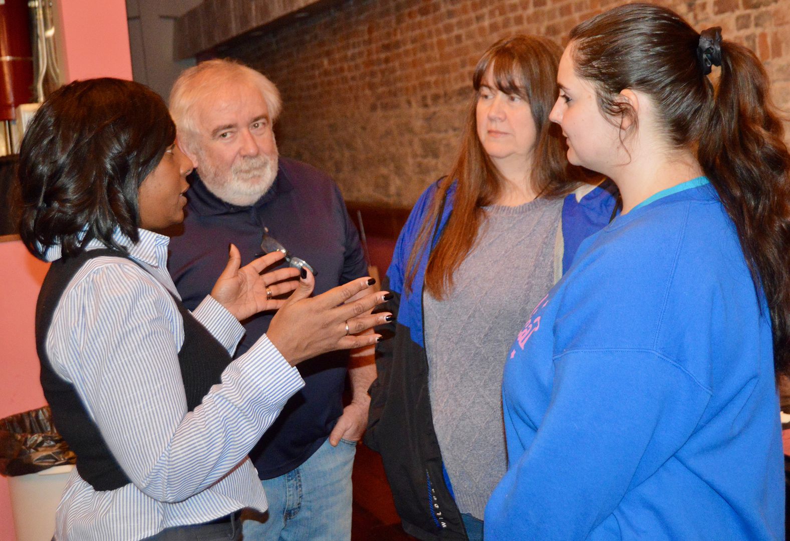 Vaché King, left, Democratic candidate for county judge-executive, talks about issues with Carl and Suzy Dent and Savanna Benningfield, right.