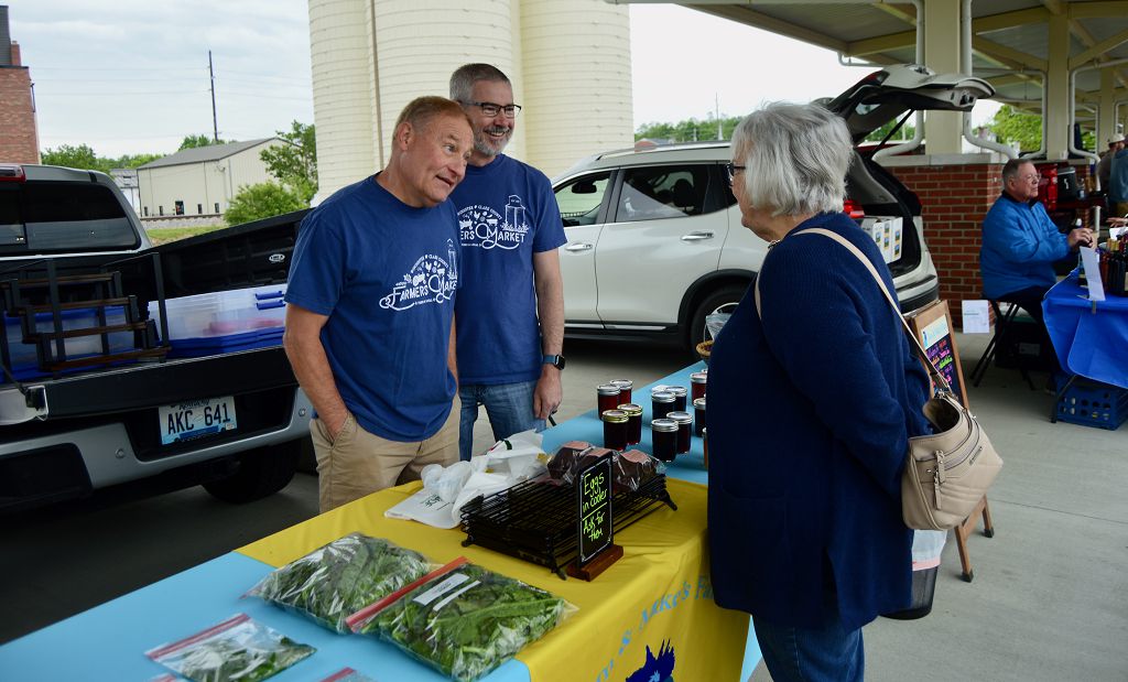 Tom Collins and Mike Childress of Tom & Mike's Farm chat with Donna Justice at opening day of the Winchester-Clark County Farmers Market.