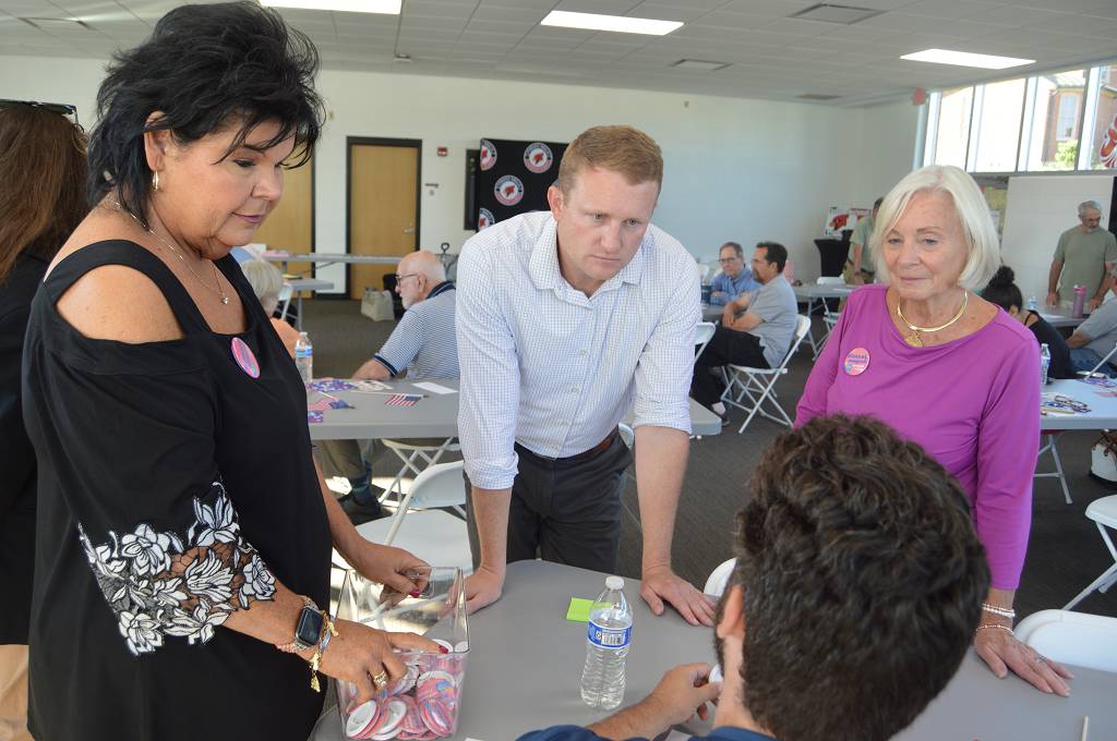 An ad against Democratic congressional candidate Zach Dembo cites an article published by WinCity Voices in July about a talk he gave at the Cardinal Community Center, but the article doesn't say what the ad implies it does. Here, Dembo is shown listening to a voter, Sean Watkins of Winchester.