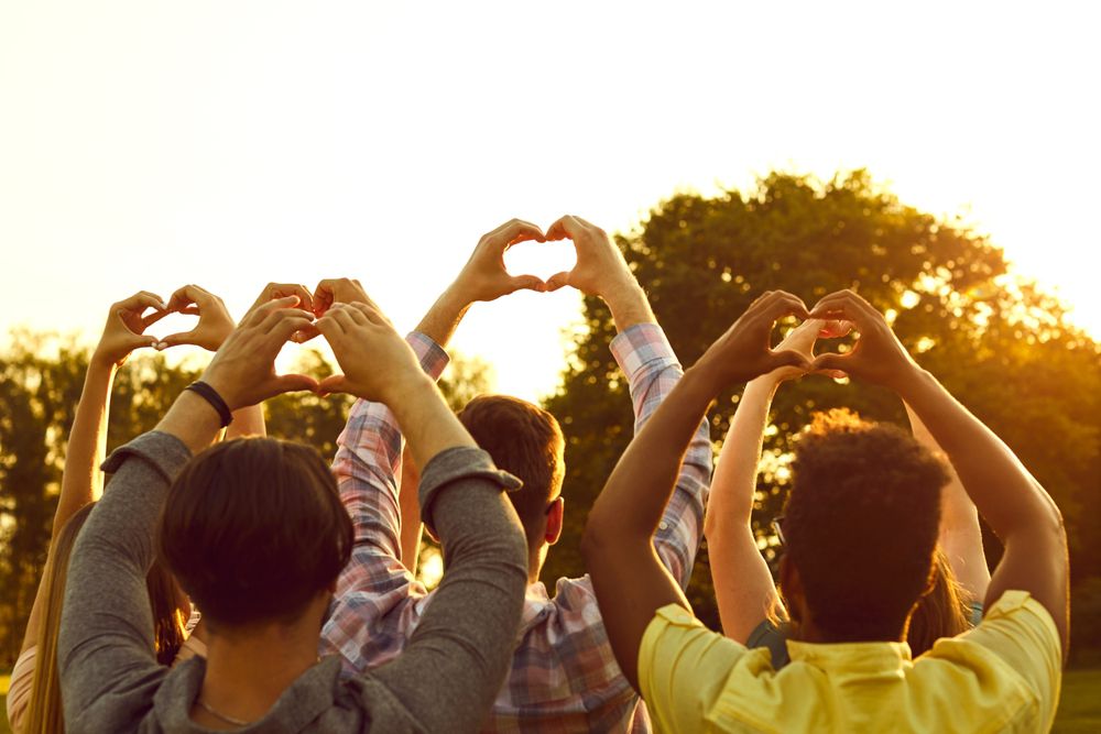 Group Of Happy Kind Adult Multiracial People Standing In Sunny
