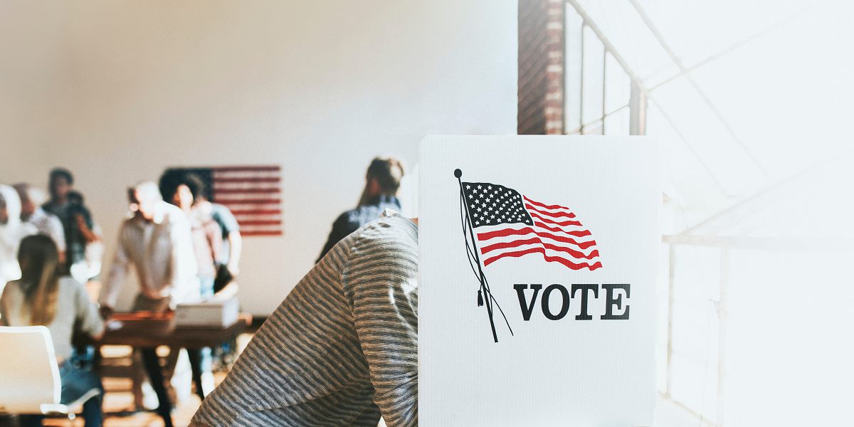 American at a polling booth (Adobe Stock image).